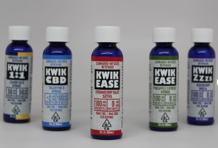 Five assorted Kwik beverage bottles displayed.